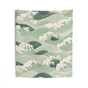 May include: A rectangular wall tapestry featuring a repeating pattern of stylized ocean waves in shades of sage green, dark forest green, and cream. The design consists of layered, curved lines forming cresting waves with white foam accents.