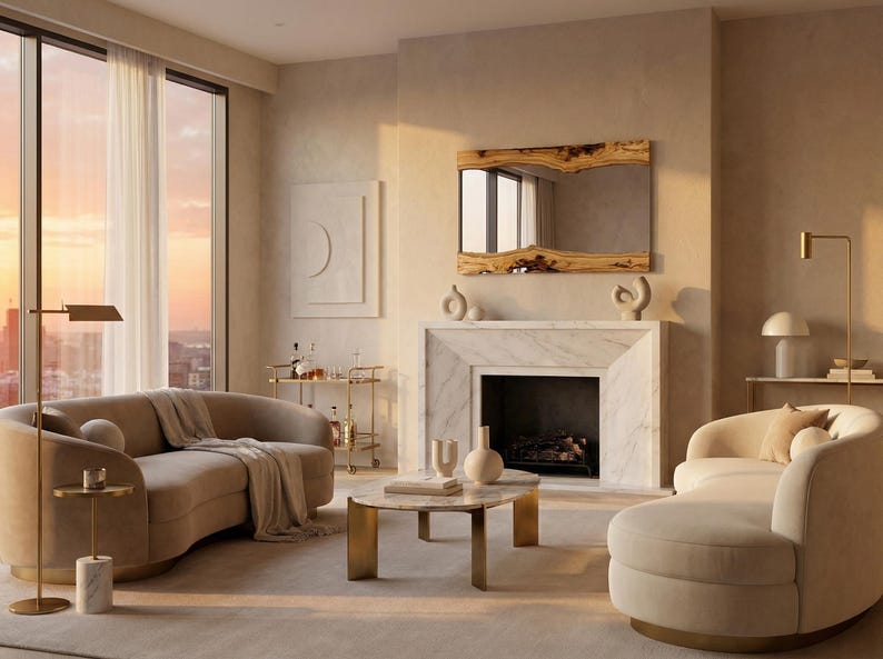 May include: An elegant living room featuring a curved beige sofa, a marble fireplace, and a large mirror with a wooden frame. A round coffee table and a chaise lounge add to the modern decor. The room is filled with warm, natural light.