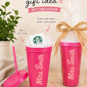 May include: A pink reusable cup with a lid and straw, personalized with "Mrs. Smith." The cup is a teacher gift idea, with text that reads "TEACHERS gift idea" and "GIFT CARD HOLDER." The cup is ready to gift, wrapped with a raffia bow.