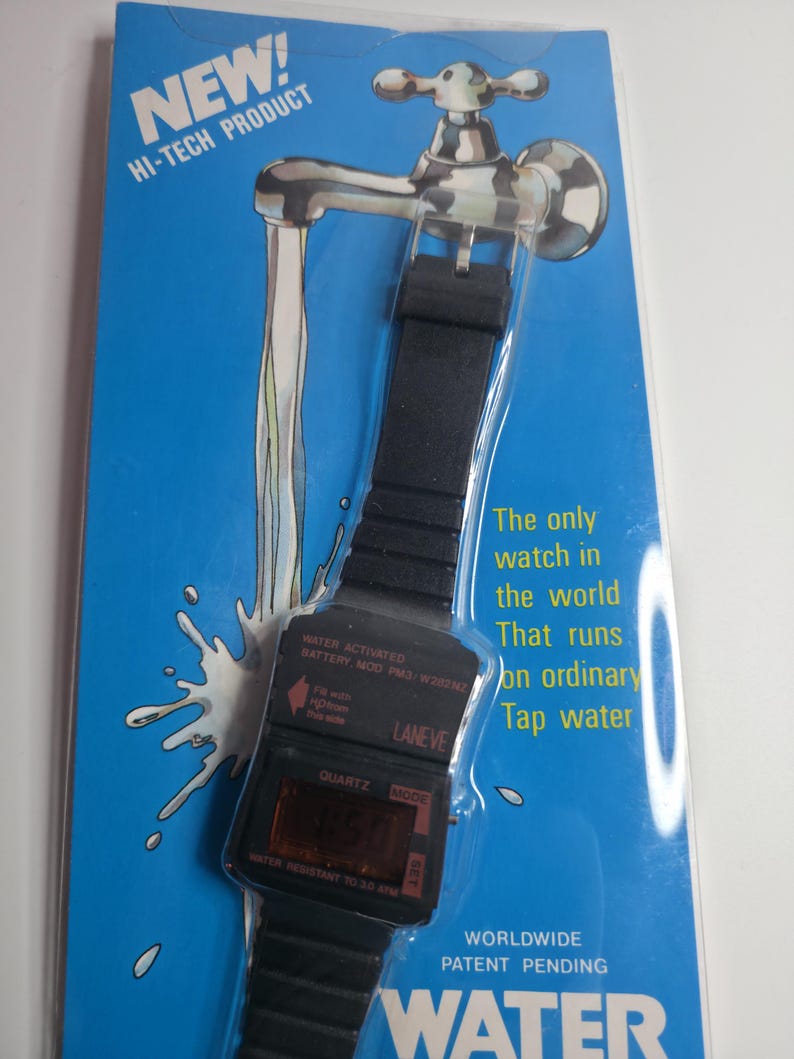May include: A black digital watch with a black band, packaged on a blue card with a faucet illustration. The watch has the text "WATER ACTIVATED" and "WATER RESISTANT TO 20 ATM". The card reads "NEW! HI-TECH PRODUCT".