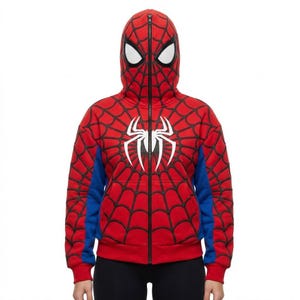 May include: Red Spider-Man zip-up hoodie with a hood that covers the head and face. The hoodie features a black spiderweb design, blue accents, and a white spider emblem on the chest. The zipper runs down the front.