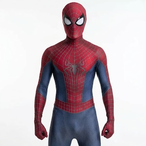 May include: A full-body Spider-Man costume in red and blue. The costume features a red mask with white eye lenses, a red torso with a black spider emblem, and blue sections on the arms and legs. The suit has a web pattern.