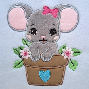 May include: Embroidered design of a gray mouse with pink ears and a pink bow, sitting in a brown flower pot with a blue heart. The pot is decorated with green leaves and pink flowers.