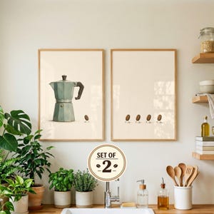 May include: A set of two framed wall art prints with a light cream background. The left print features a light blue moka pot and a single coffee bean with legs. The right print displays four coffee beans with legs walking in a line.