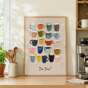 May include: A framed print featuring a collection of colorful, illustrated mugs. The mugs are in various colors and patterns, with the phrase "Tea time?" at the bottom. The artwork is displayed on a light beige background.