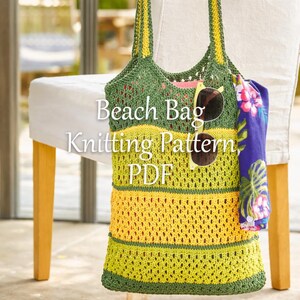 May include: A handmade green and yellow knitted beach bag with the text "Beach Bag Knitting Pattern PDF". The bag has a striped design and is hanging on a chair. Sunglasses and a floral scarf are attached to the bag.