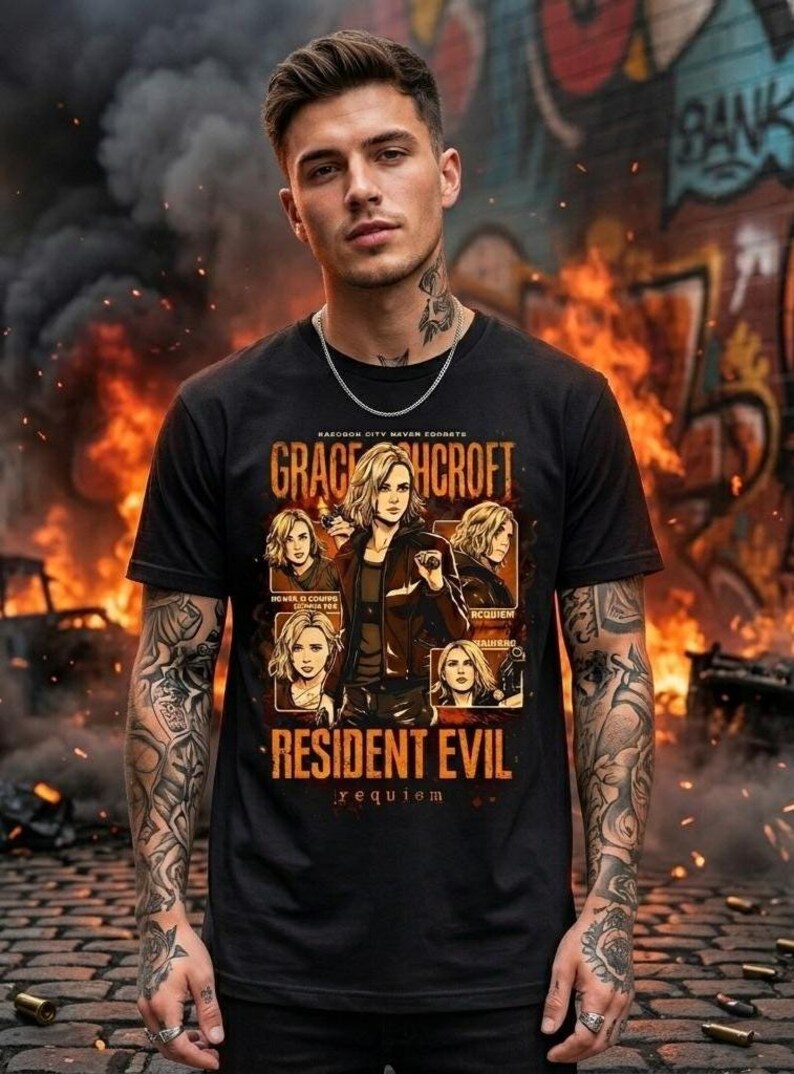 May include: Black t-shirt featuring a graphic of Grace Hcrof, from Resident Evil: Requiem. The design includes portraits and text. The background shows flames and graffiti. The shirt is worn by a person with tattoos and a silver chain.