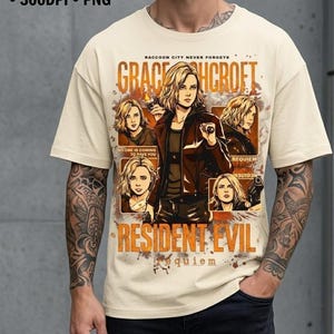 May include: Cream-colored t-shirt featuring a graphic of a woman with the text "GRACE HCROFT" and "RESIDENT EVIL". The design includes multiple images of the woman and the words "RACCOON CITY NEVER FORGETS", "REQUIEM", and "NO ONE IS COMING TO SAVE YOU".