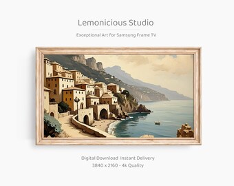 May include: A framed digital art print depicting a coastal town with beige buildings, a stone bridge, and a calm blue sea. The artwork is in a watercolor style, with the text "Lemonicious Studio" at the top.