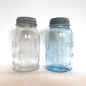 Atlas Strong Shoulder Mason 1 Quart Canning Jar with original zinc twist lid from 1910s-1920s in clear or blue glass