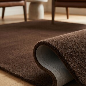 Macro shot highlighting the 13-16mm thick Premium New Zealand wool pile of this brown area rug, known across Europe as an elite luxury Tapis en laine.

Wide interior angle showing the perfect scale and rich solid brown palette, ideal for anchoring contemporary, minimalist, and boho decor.