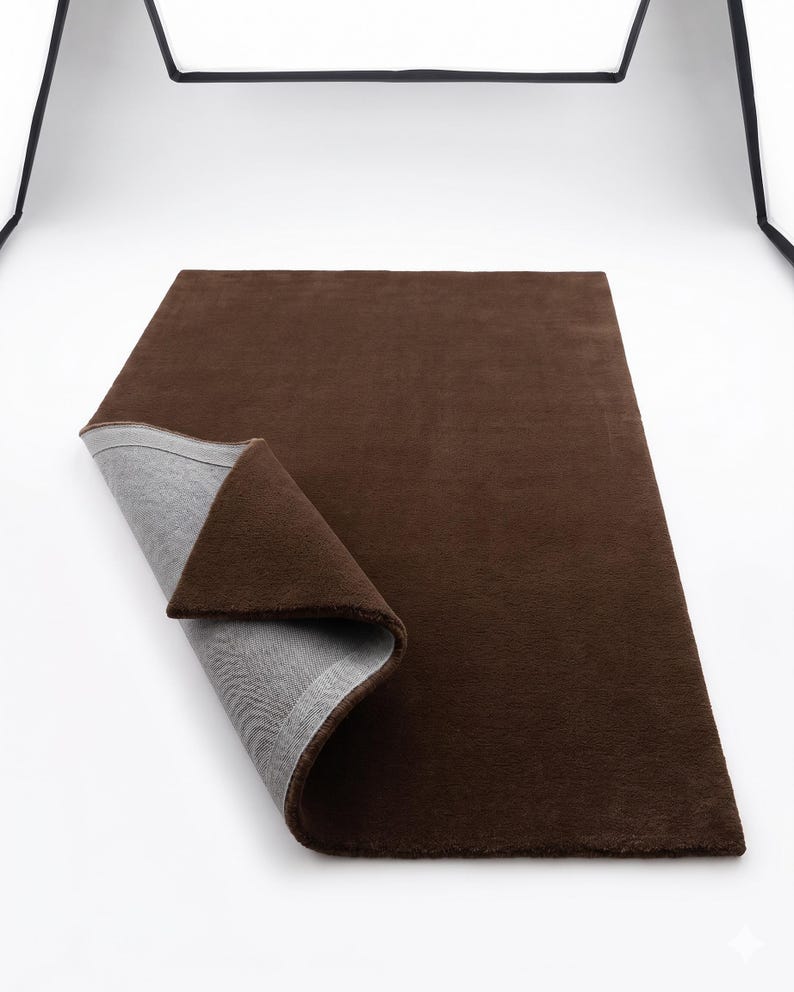 High-detail view showcasing the deep, uninterrupted mocha brown fibers, displaying exquisite handcrafted rugs artistry with a beautiful matte finish.