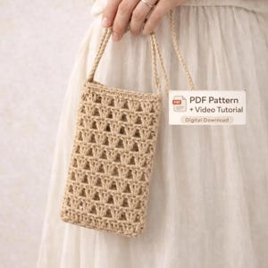 May include: A beige crochet phone bag with a woven pattern and a shoulder strap. The bag is rectangular and has a textured appearance. The image includes text that reads "PDF Pattern + Video Tutorial Digital Download."