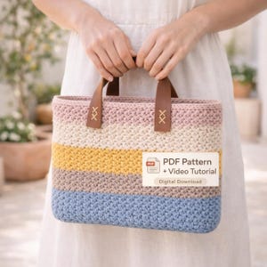 May include: A crocheted tote bag with horizontal stripes in pastel colors: pink, cream, yellow, brown, and blue. The bag has brown leather handles with decorative stitching. The text "PDF Pattern + Video Tutorial" is visible.