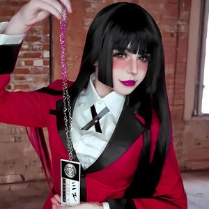 May include: A red blazer with black lapels and a white collared shirt. The image features a black wig with bangs and a silver chain with a pink beaded strand. A card with Japanese text is held up.