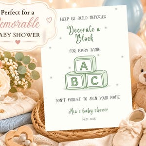 May include: A white rectangular sign with green text and a drawing of three alphabet blocks labeled A, B, and C. The text reads: Help us build memories, Decorate a Block for Baby Jamie, Don't forget to sign your name, Mia's baby shower, 14.01.2016.