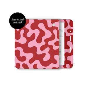 May include: A red and pink patterned case with a white interior. The case is open, revealing a white item inside. A black circle with the text "Easy to peel and stick" is in the upper left corner.