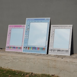 Op de afbeelding: Drie rechthoekige spiegels ontworpen als de Windows Paint-programma-interface. De spiegels hebben een lichtblauwe, roze en grijze kleurstelling met de titelbalk "untitled-Paint" en pictogrammen van de werkbalk. De tekst "For Help, click Help Topics on the Help Menu" is zichtbaar.