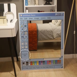 May include: A white ceramic mug with a black handle and the text "But First, Coffee" in a bold, black font. The mug is set against a blurred background, suggesting a cozy setting. The mug appears to be approximately 4 inches tall.