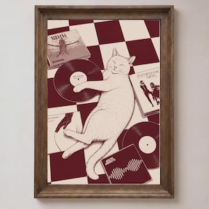 May include: A framed art print featuring a white cat lying on a maroon and cream checkered floor surrounded by vinyl records and album covers including Nirvana's Nevermind, Fleetwood Mac's Rumours, The Strokes' Is This It, and Arctic Monkeys' AM.