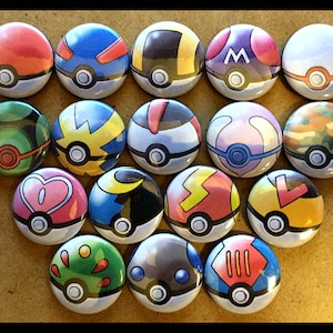 May include: A collection of 16 colorful Poke Ball buttons. Each button features a different design, including a red and white Poke Ball, a blue and white Poke Ball, and a green and white Poke Ball.