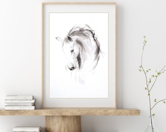 May include: A black and white watercolor painting of a horse's head, framed in a light wood frame, hanging on a white wall above a wooden shelf with two shelves. A clear glass vase with a small branch with green leaves is on the shelf.