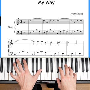 Könnte beinhalten: Noten für "My Way" von Frank Sinatra, mit Klaviernotation. Der Titel und der Name des Komponisten sind sichtbar. Hände spielen auf den Klaviertasten, wobei die schwarzen und weißen Tasten im Fokus stehen.