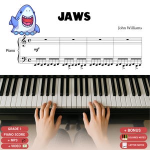 May include: A piano sheet music page for Jaws by John Williams featuring a cartoon shark illustration, musical staff notation with piano clefs, and a view of hands playing a black and white piano keyboard with bonus labels for colored and letter notes.