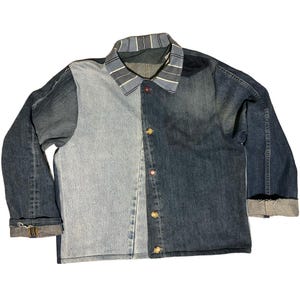 May include: A white ceramic mug with a black handle and the text "But First, Coffee" in a handwritten style. The mug is on a white surface. The mug is likely for hot beverages.