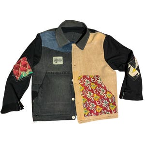 May include: A patchwork jacket with a unique design. The jacket features a mix of black, denim, and tan panels. Decorative patches with red and yellow accents are sewn on the sleeves. The jacket has a button-up front and a collar.