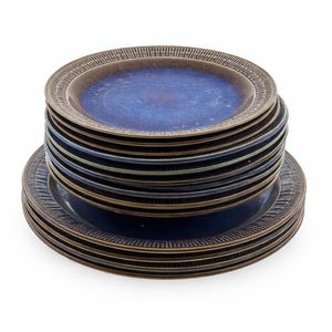 May include: A white ceramic mug with a black handle and the text "But First, Coffee" in a bold, black font. The mug is set against a neutral background, highlighting its simple design.