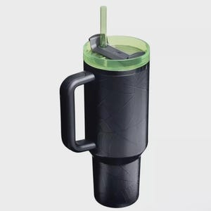 Op de afbeelding: Zwarte ge&iuml;soleerde beker met een handvat, groene deksel en rietje. De beker heeft een getextureerd oppervlak met een geometrisch patroon. De beker is ontworpen voor ongeveer 887 ml.