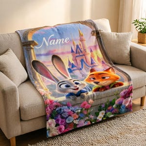 May include: A soft blanket displaying Judy Hopps and Nick Wilde from Zootopia, with a castle scene and the word "Name". The blanket is on a beige sofa, with a vibrant floral border. The scene is reminiscent of a fairytale.