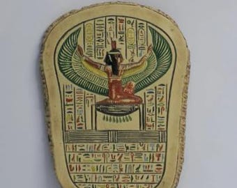 Old-fashioned wall relief of isis goddess of protection and magic with her wings
