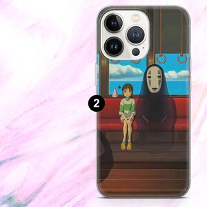 May include: A clear phone case featuring a scene from an animated film. The design shows a girl in a green and white striped shirt and a figure with a white mask sitting on a red bench inside a train car. The background shows a blue ocean and sky.