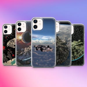 May include: Five phone cases with Star Wars designs. The cases display images of the Millennium Falcon, space battles, and planets. The cases have a clear border and are set against a gradient background of pink, purple, and blue.