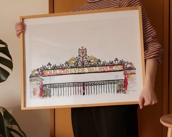May include: A framed watercolor painting of the Anfield stadium gate with the words "You'll Never Walk Alone" in gold lettering.