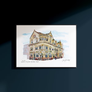 May include: Watercolor print of "The Phil" Philharmonic Dining Rooms, Hope Street, Liverpool. The building is a detailed illustration with a cream and tan facade, ornate windows, and a blue sky background.