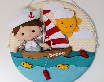 A cute little fisherman on his boat, on a light wreath to hang on  your nursery