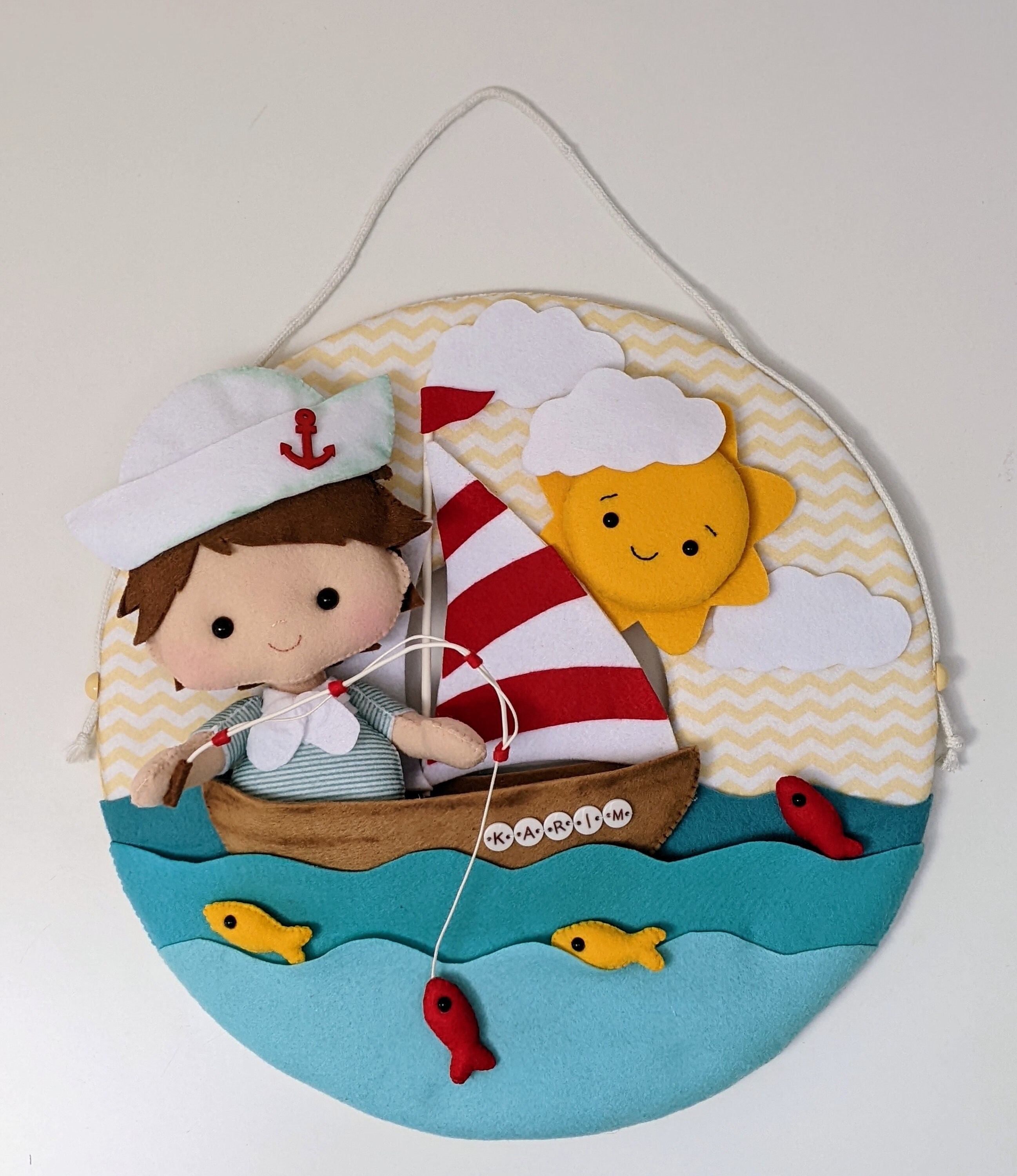 A cute little fisherman on his boat, on a light wreath to hang on  your nursery, wall decor, bedroom personalized door sign, nursery decor