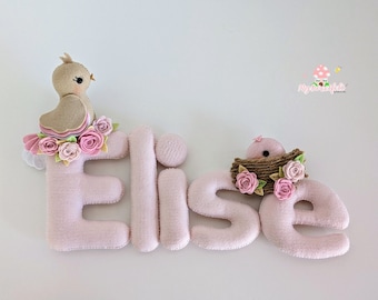 A delicate bird name banner for a lovely nursery