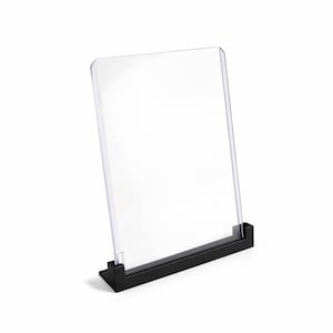 May include: A white ceramic mug with a black handle and the text "But First, Coffee" in a black, bold font. The mug is on a white surface.