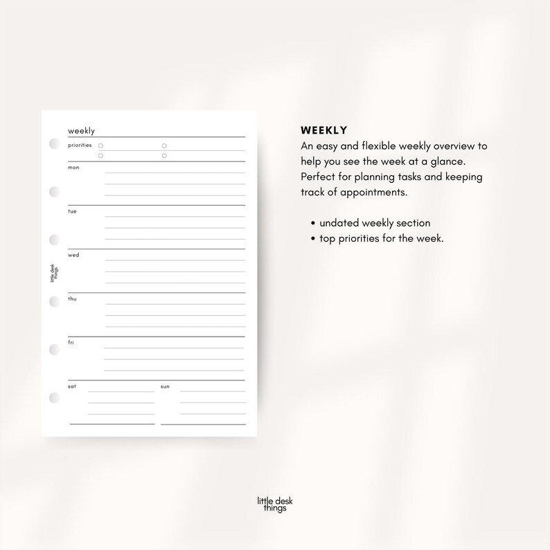 May include: A white weekly planner insert with a minimalist design. The planner includes sections for priorities and daily scheduling, with the days of the week labeled. The text "WEEKLY" is at the top, along with bullet points describing the planner's features.