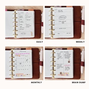 May include: A brown leather planner with gold rings, open to reveal four different pages. The pages are labelled "Daily", "Weekly", "Monthly", and "Brain Dump". Each page contains handwritten notes and a pen.