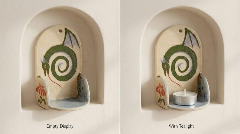 May include: Ceramic candle holder with a dragon design. The holder is off-white with a green dragon, red tongue, and purple wings. A tealight candle sits in the holder in the second image. The text "Empty Display" and "With Tealight" are below the images.