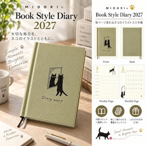 May include: A sage green 2027 book-style diary featuring a black cat illustration looking into a mirror on the cover. The diary includes two ribbon bookmarks, monthly calendar pages, and weekly planning pages with various cat illustrations.