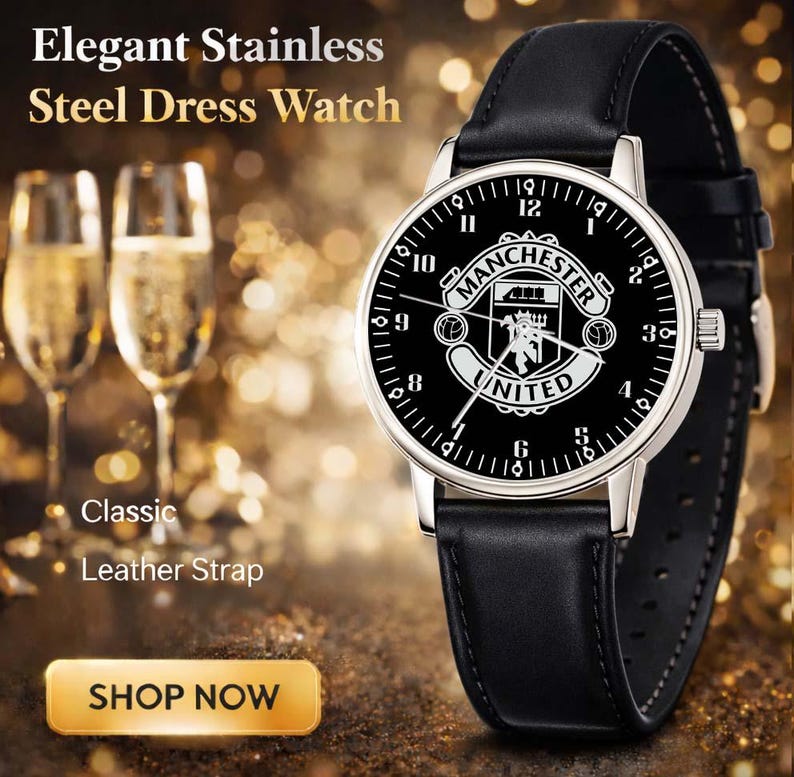 May include: Elegant stainless steel dress watch with a black leather strap. The watch face is black with white numerals and the Manchester United logo. The watch has a silver-colored bezel and a classic design.