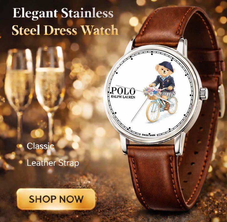 May include: Stainless steel dress watch with a brown leather strap. The watch face features a bear riding a bicycle, with the "POLO RALPH LAUREN" logo. The watch has a classic design.
