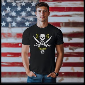 May include: A black short-sleeved t-shirt featuring a white graphic of a skull and crossbones with the number 26 above it. Below the swords, the word ERRANT is printed in yellow, followed by a small white graphic of a stylized head.
