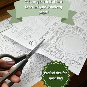 May include: A pair of scissors cutting a printed activity page with the text "Cut along the dotted lines to create your 6 Activity pages!". The page features a crossword puzzle, drawing prompts, and other activities. A green starburst graphic says "Perfect size for your bag".